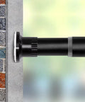 Close-up of black adjustable room divider tension rod 122 to 150 inches no drilling, strong hold on wall