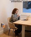 Woman working near Portable 450W Plug In Heater With Remote, Clear LED Display, 180 Degree Rotatable Plug, Compact for small spaces