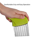 Crinkle cutter with green plastic handle and stainless steel wavy blade, close-up.