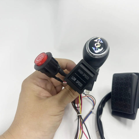 Hand holding gear shift and wiring from 12V Harness Conversion Kit For Kids Ride On Toys DIY Upgrade Set with 40A Controller.