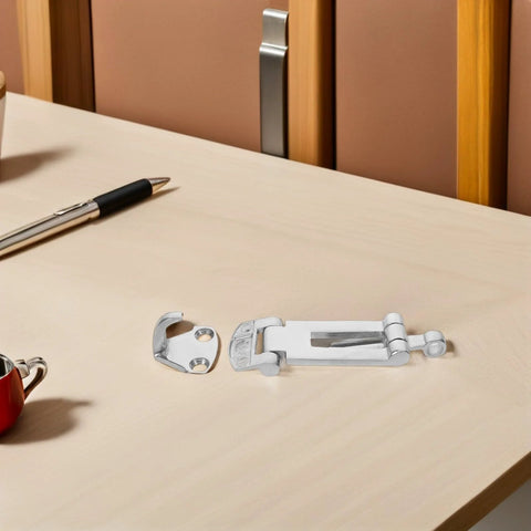 Stainless steel toolbox latch set, two-piece with anti-rattle mechanism, resting on a light wooden desk