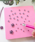 Person using Four Bead Sizes Polymer Clay Bead Roller Kit With Bead Maker And Molds For Clay Crafting on pink surface
