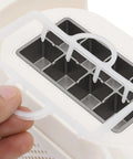 Great Slick And Totally Nifty Mini Countertop Ice Maker With 12V Car Adapter And Fast Freeze Cycle Portable Cube Maker For RV Campers Cars Homes And Road Trips Everywhere showing ice tray.