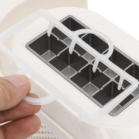 Great Slick And Totally Nifty Mini Countertop Ice Maker With 12V Car Adapter And Fast Freeze Cycle Portable Cube Maker For RV Campers Cars Homes And Road Trips Everywhere showing ice tray.