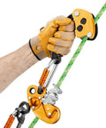 Hand holding Zigzag Plus Descender For Arborists With Smooth Rope Feed And Auto Locking Friction Chain Tree Climbing Rope Descender.