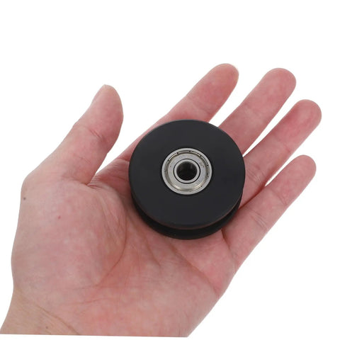 Two Pack Fixed Pulley Roller For Gym Cable Systems Quiet Nylon Wheel Replacement For Home Gym And Hospital Fitness Equipment With Dual Bearing Silent Operation Pro Grade, black pulley wheel in hand