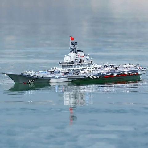 Dual-Motor 30 Km/H RC Battleship with Waterproof Hull on water surface, showcasing sealed cabin and remote control features.
