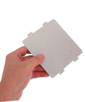 Hand holding a silver microwave mica waveguide cover from Universal Fit Microwave Mica Sheets For High Heat Insulation And Protection, Cuttable 10 Pack