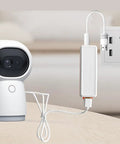 Mini UPS Battery Backup With 2600mAh Rechargeable Lithium Cell powers a security camera plugged into a wall outlet.