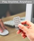 Heavy Duty Metal Fidget Slider Featuring Unlimited Rotary Push Brick Design For Adults ADHD Anxiety And Stress Relief Smooth As Butter Gliding Action Kick Back And Chill Anytime held in hand near computer.