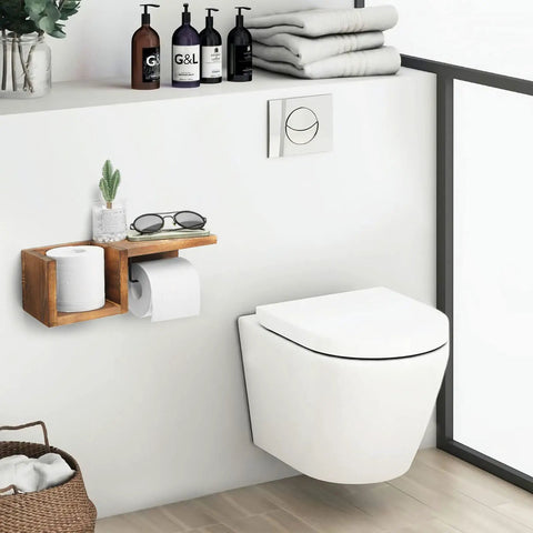 Bathroom setting with Wooden Toilet Paper Holder Wall Mount with Shelf, storing a tissue roll, plant, and glasses over a toilet.
