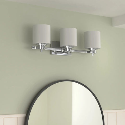 Chrome Vanity Bath Light Fixture With Etched Glass, Three Lights, 24 Inch Wide, mounted above a bathroom mirror