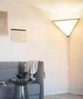 Triangle Corner Light With Switch, Plug In Ceiling Lamp for Living Room accenting a modern sofa in a bright room corner.