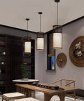 YAXDQUW Modern Style Bamboo Pendant Light Handcrafted Hanging Ceiling Lamp in dining area with three shades.