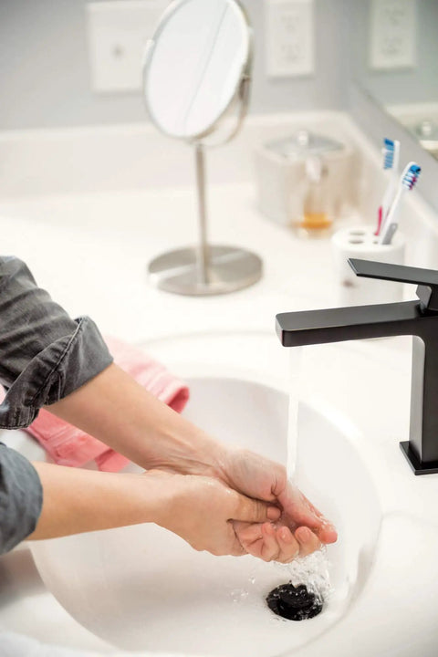 Person washing hands under High Arc Matte Black Lavatory Faucet With 1 Or 3 Hole Install in modern bathroom sink
