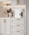 Champagne Bronze Cabinet Pulls Two And A Half Inch Brushed Bronze Drawer Handles installed on white kitchen cabinets.