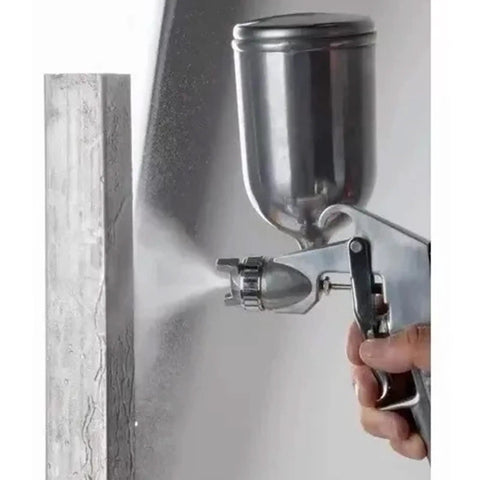 Pneumatic Paint Spray Gun With 400ML Aluminum Cup delivers a fine mist for coating, featured alongside a wooden surface.