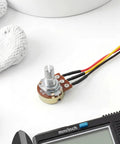 10K Linear Taper Rotary Potentiometer with knurled shaft and prewired XH2.54 cable on white surface.