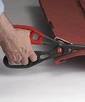 Hand using All Purpose Snip For Vinyl Siding Aluminum Trim Coil Vinyl Flooring Carpeting Leather And Landscaping Edging A Heavy Duty Alloy Steel Blade