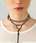 Dope Love Heart Choker Necklace Crafted From Thick Vinyl Leather Collar With Soft Plush Velvet Lining Adjusts Easily For Necks Up To Fifteen Inches Stacks Well With Body Chains For A Badass Gothic Vibe worn on a model.
