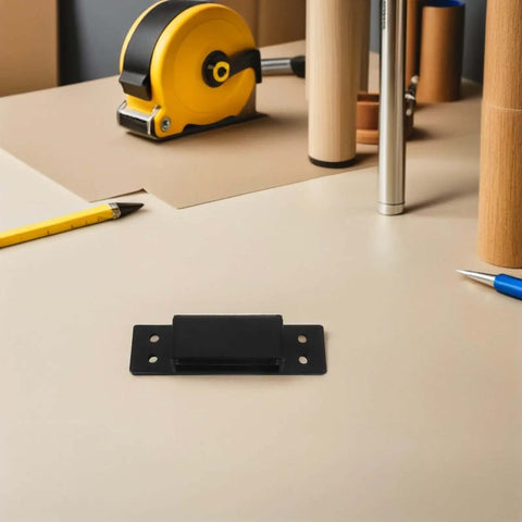 Hidden Door Hinge 5 Inch Black Concealed Pivot for cabinets and secret doors positioned on a beige table with tools