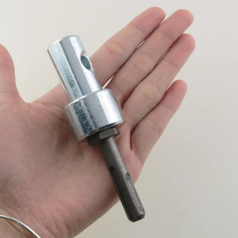 Earth Drill Adapter For Garden Augers Four Inch And Six Inch Connect To One Half Inch Shafts Silver Tone held in hand