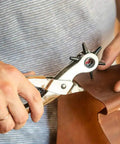 Person using Heavy Duty Pro Grade Leather Hole Punch Tool Set With Revolving 6 Size Punches on leather material