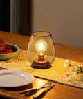Set Of 4 Battery Operated LED Table Lanterns In Rustic Brown Metal Cage on a dining table
