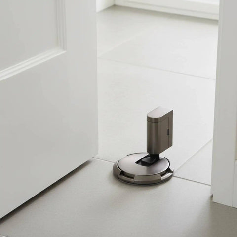 Solid Zinc Alloy Door Stopper With Suction Holder For Floor And Walls Holds Tight Against Wind To Keep Bedroom Office Quiet And Safe From Slams on tiled floor.