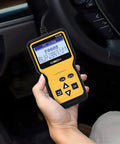 Hand holding yellow OBD2 Scanner Code Reader for Cars Read and Erase Fault Codes Check Engine Light Emission Monitor Real Time Data