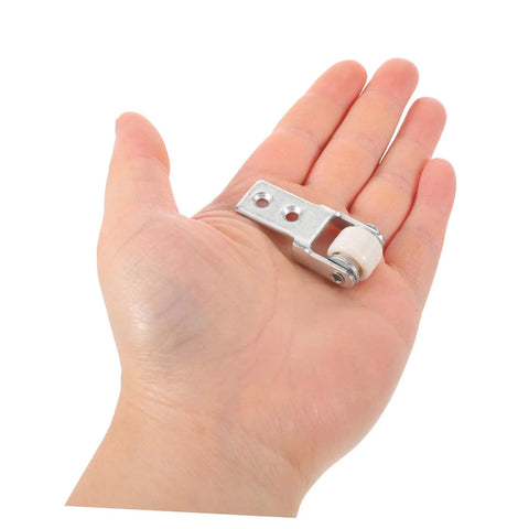 Six Piece Set Of One Inch White Nylon Sliding Roller Guide Wheels For Heavy Duty Furniture And Cabinet Drawer Tracks, shown on hand.