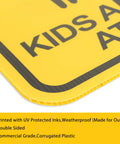 Close-up of a yellow sign corner with printed text, corrugated edge shown, part of Slow Down Signs With H Stake 16x12 Inches Kids And Pets At Play Double Sided Street Safety Signs Waterproof Fade Resistant Weatherproof Durable Pack Of 3 For Driveways And Neighborhoods.