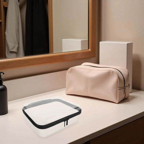 Built Different Clear Hard Shell Zipper Case For Travel Toiletries And Makeup Organizer on a bathroom counter next to a pink pouch.