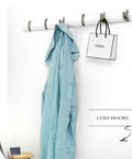 Built Tough Eight Hook Wall Mounted Coat Rack Featuring Rustproof Steel Fold Down Design for easy storage of a shirt and bag.