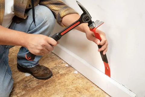 Person using 15 Inch Flat Pry Bar With Grip For Demolition And Prying Nails Precision Ground Edges Beveled Nail Slots rusty-resistant finish
