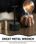 Person holding light bulb next to black socket wrench tool, part of Nonslip Socket Ring Removal Tool For E14 E26 E27 G9 Lamps No Sweat Install