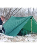 Person setting up Egret Nylon Tarps 12 By 16 Feet Green Lightweight Yet Tough Outdoor Tarp for Camping And DIY Projects in snow