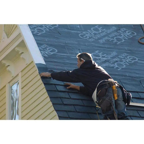 Worker installing Rock Solid Self Adhering Ice And Water Shield Roof Underlayment 36 Inch By 66.6 Feet on sloped roof.