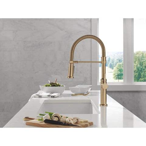 Pro Level Commercial Spring Neck Kitchen Faucet With Magnetic Docking Pull Down Sprayer Diamond Seal Tech Hella Smooth Handle Action In Champagne Bronze, shown on a kitchen sink.