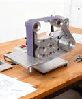 Rock Solid Shop Grade Belt Sander And Polisher With Heavy Duty 750 Watt Motor For Efficient Woodworking Trimming And Dual Vertical Grinding Work on a wooden table.