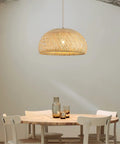 Roomy Bamboo Plug In Pendant Light With Dimmable Switch And 14 Foot Handmade Woven Cord above a wooden dining table.