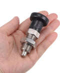 Pair Of Stainless Steel Push Fit Ball Nose Spring Plungers And M16x1.5 Return Knobs in hand showing M16x1.5 thread and grip.