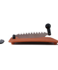 Side view of Anjali Fantastique Deluxe stainless steel vegetable cutter on a wooden base with a black handle.