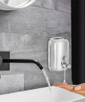 Heavy Duty Stainless Steel Wall Mount Soap Dispenser With Smooth Glide Manual Pump And Ergonomic One Touch Operation No Fuss Commercial Grade Setup For Bathroom Kitchen Solid Five Hundred Milliliter Storage Tank in use with hand.