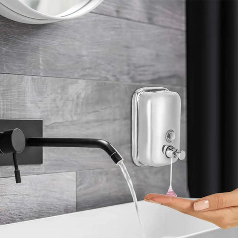Heavy Duty Stainless Steel Wall Mount Soap Dispenser With Smooth Glide Manual Pump And Ergonomic One Touch Operation No Fuss Commercial Grade Setup For Bathroom Kitchen Solid Five Hundred Milliliter Storage Tank in use with hand.