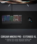 Top view of MM350 PRO Extended XL Spill Proof Cloth Gaming Mouse Pad with keyboard and mouse on 930mm by 400mm surface, black.