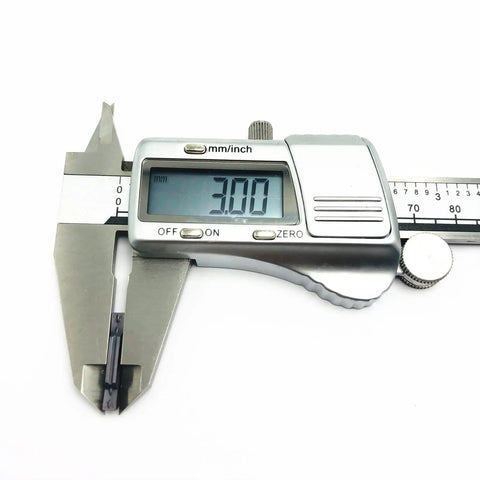 High Performance Carbide Grooving Insert PC9030 MGMN300‑M measured at 3.00 mm using a digital caliper for CNC lathe tasks.