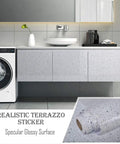 Realistic terrazzo sticker on cabinets, glossy surface, next to washing machine and countertop in a modern bathroom.