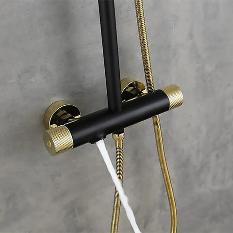 Close-up of the wall-mounted fixture with black and gold accents in Chill Out With This Top Tier Wall Mounted Shower Set.