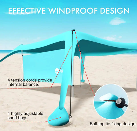 Close-up of blue 10x10 beach shade canopy tent with sidewalls showing windproof design setup on sand with guylines.